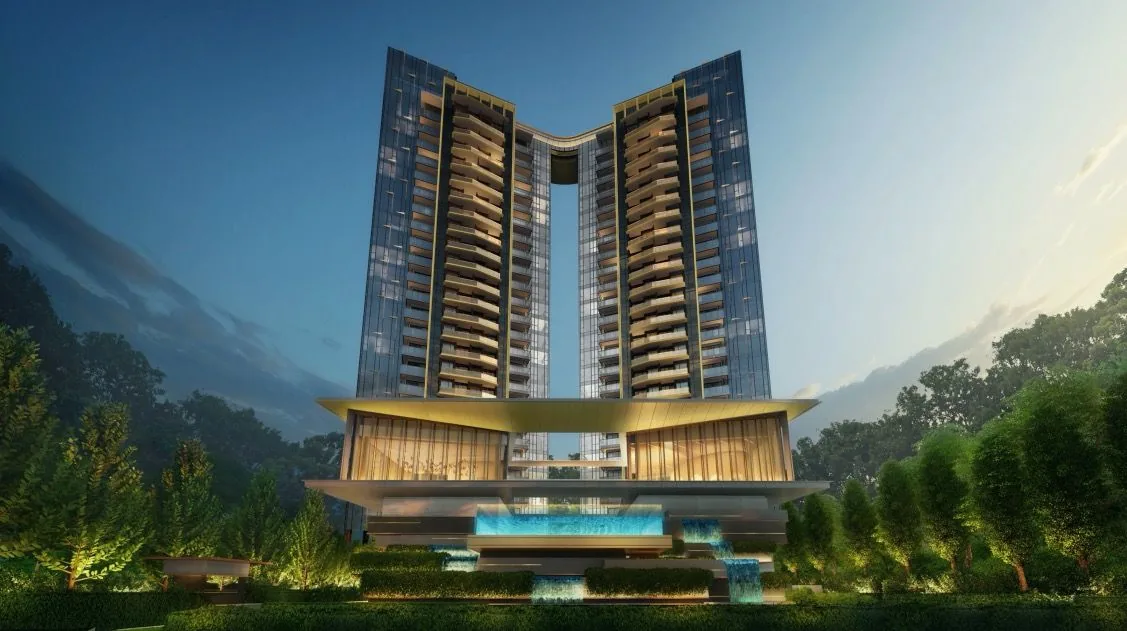 Twin-tower new launch condominium in Singapore lit at dusk, with the arrival deck and reflecting pool below