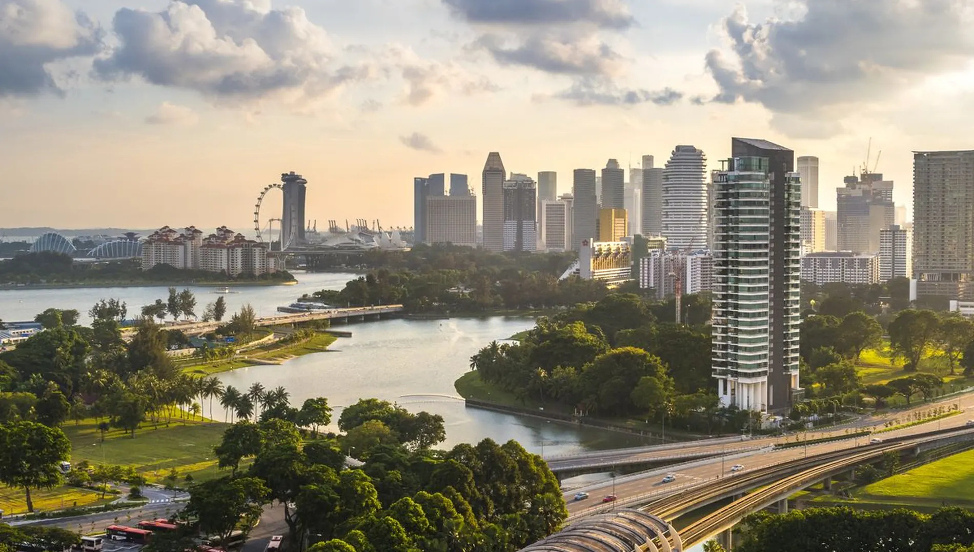 Singapore city skyline at sunrise across the Kallang Basin