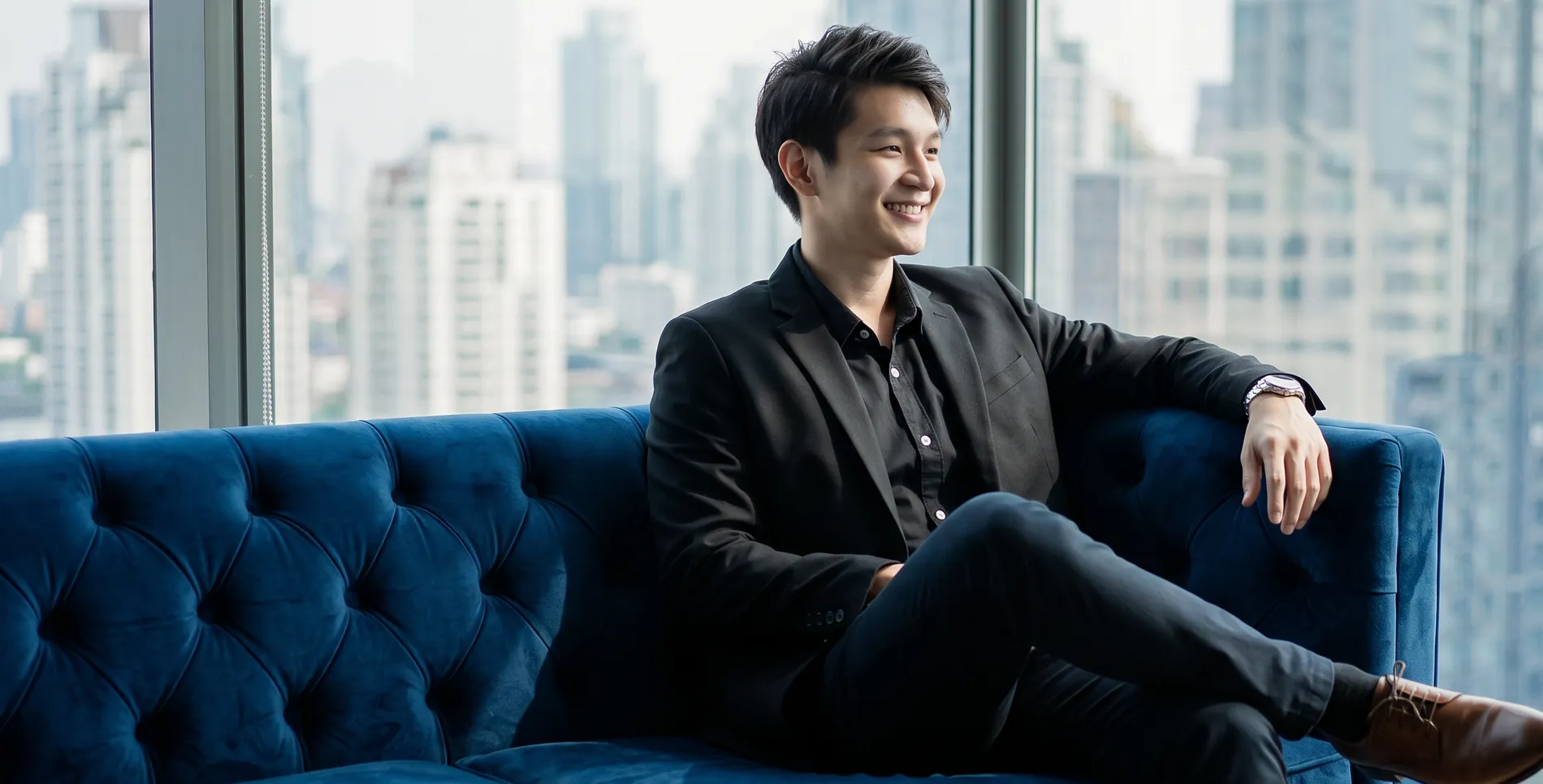 Jamus Lee, licensed Singapore property advisor with ERA and founder of PropertyInsider.sg, seated by a city skyline window