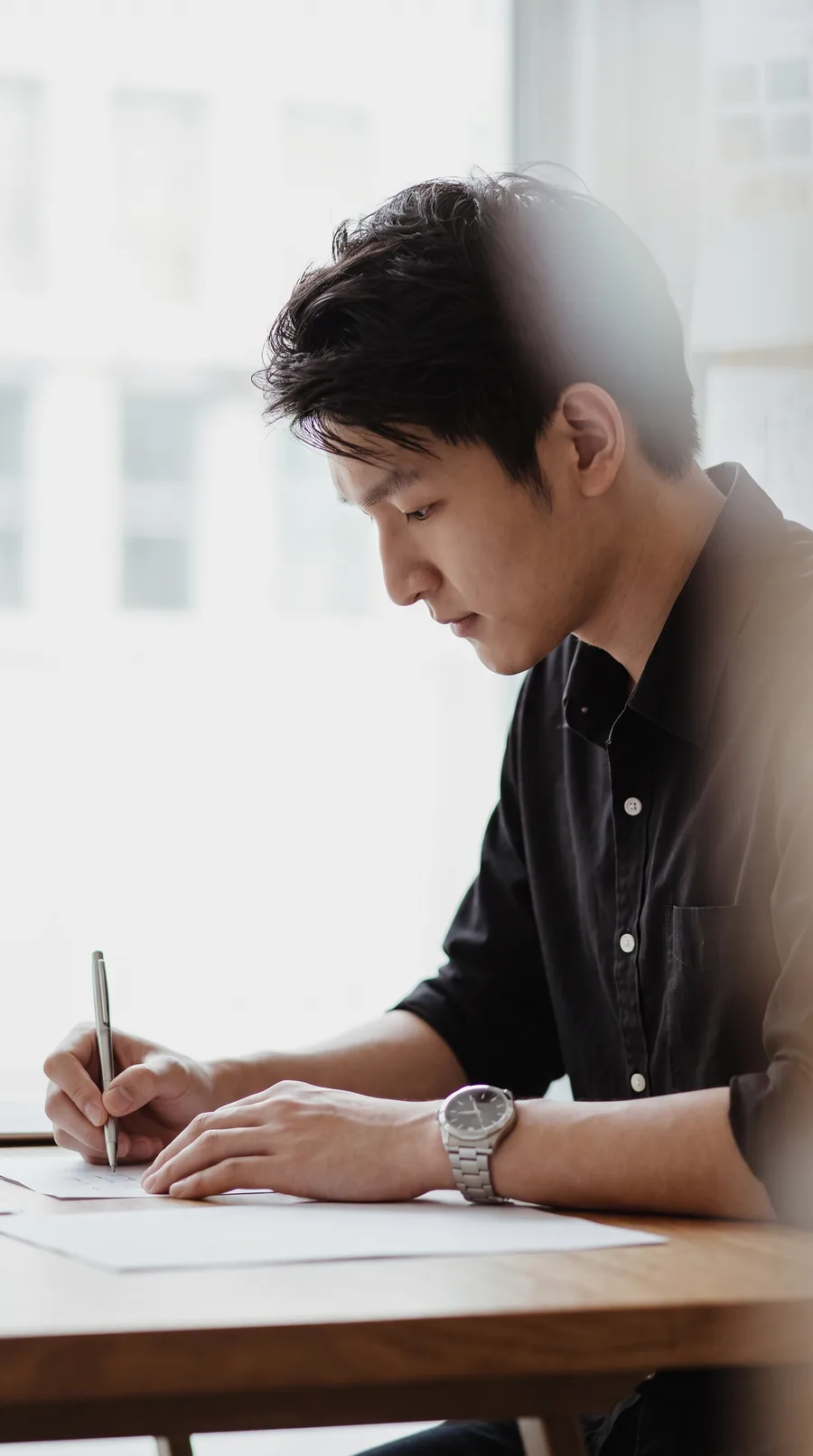 Jamus Lee working through property figures by hand