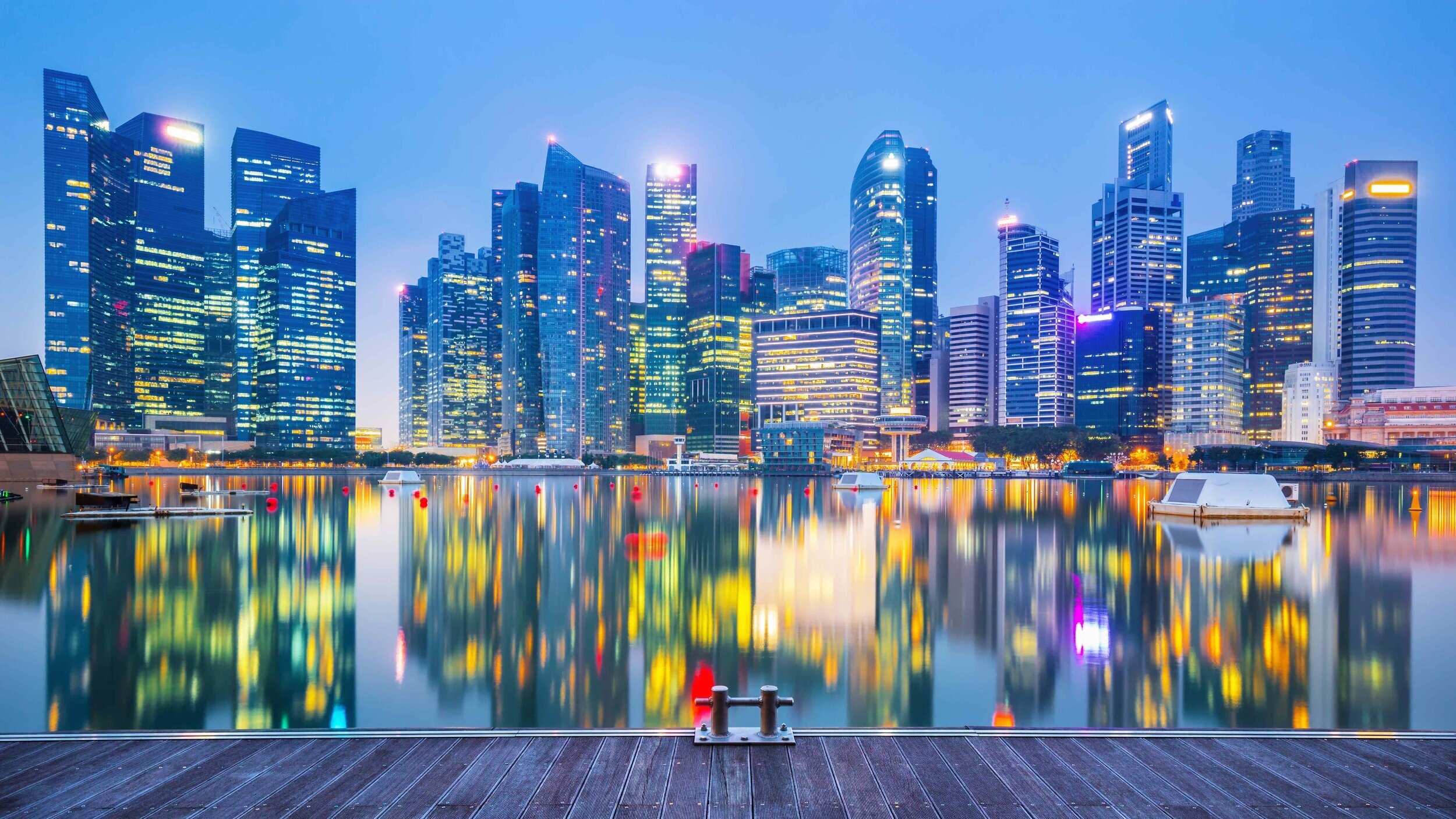 Singapore city skyline at dusk — illustrating the importance of location in Singapore property investment decisions, whether choosing a new launch or resale condo in 2026