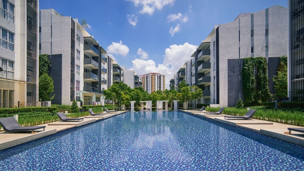 Singapore condominium lifestyle amenities — resort-style swimming pool and landscaped grounds typical of new launch and premium resale condos, showcasing the lifestyle appeal for buyers in 2026
